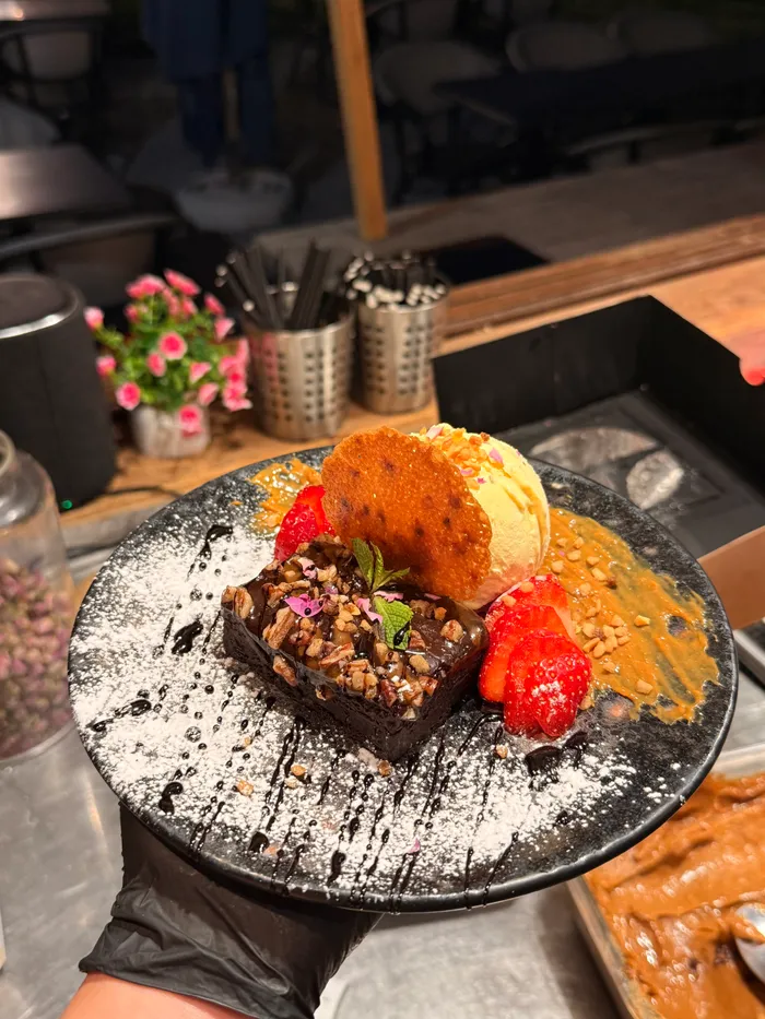 A plated chocolate dessert with strawberries, made at work